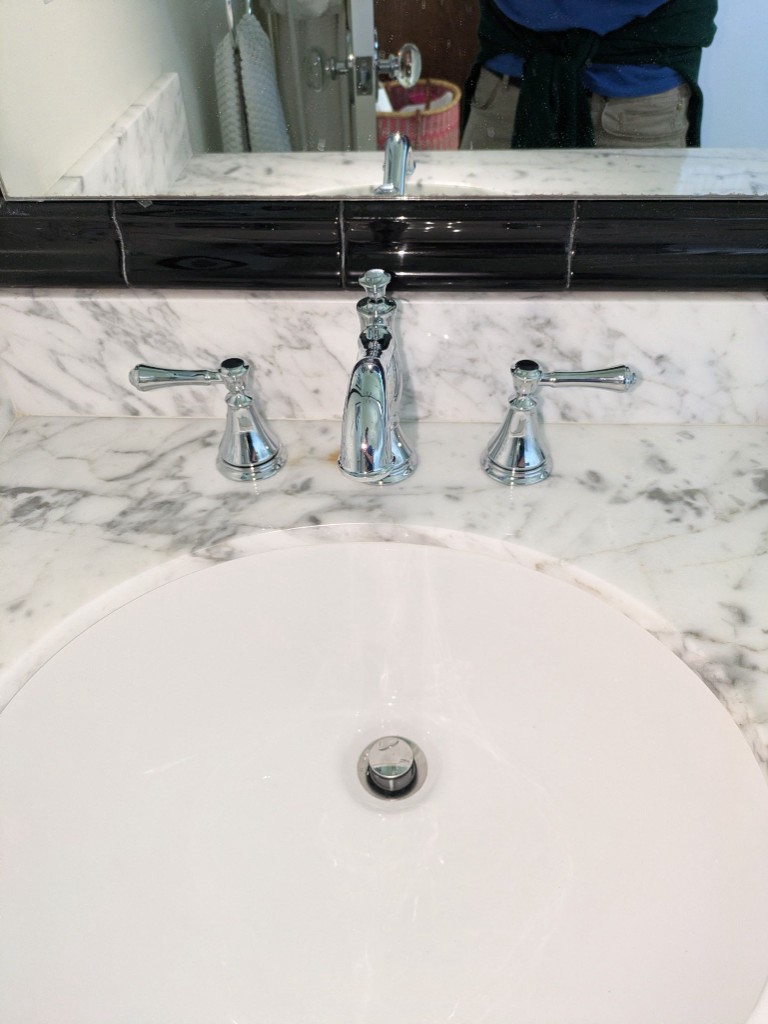 Bathroom sink, faucet, and marble countertop — general plumbing fixtures in a Cypress TX home