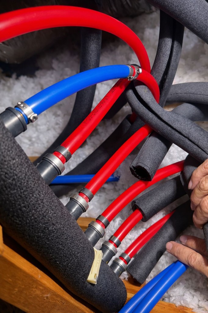 PEX hot and cold water lines with professional crimp fittings and insulation during whole home repiping